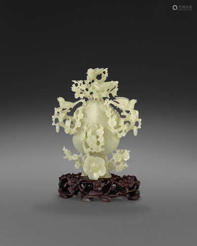 A carved jade lidded vase with bird and flower decoration