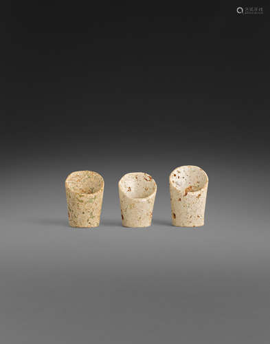 a group of Three small hoof-shaped hardstone ornaments