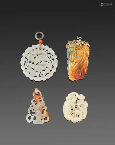 a group of Four jade pendants