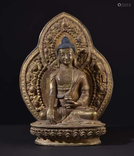 Buddha Shakyamuni. Old Tibetan or Chinese gilt bronze statue. Old repousse aureole.