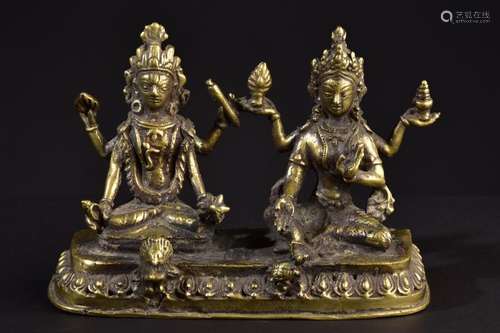 Hindu deities Vishnu and Lakshmi. Old Nepalese brass sculpture.