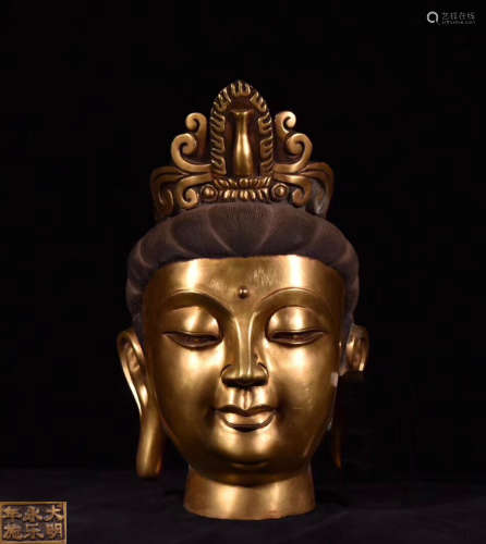 A GILT BRONZE MOLDED BUDDHA HEAD STATUE