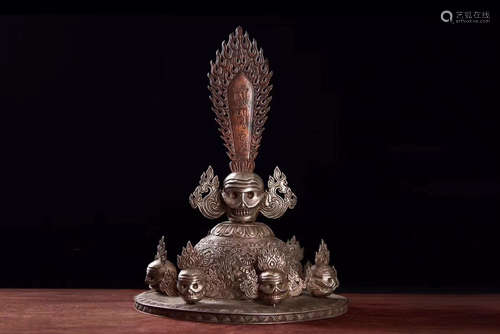 A SILVER MOLDED TIBETAN BUDDHIST HAT