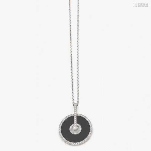 PIAGET PENDENTIF DISQUE ONYX ET DIAMANTS An onyx, diamond and gold pendant with chain by PIAGET.