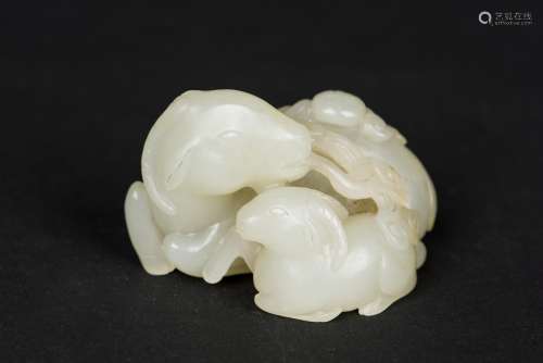 A PALE GREEN JADE CARVING OF TWO SHEEP