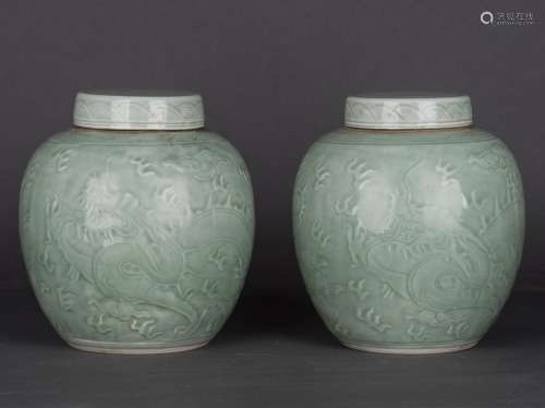 A PAIR OF CELADON-GLAZED 'DRAGON' JAR AND COVERS, REPUBLIC PERIOD