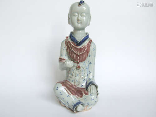 A BLUE AND RED GLAZED BOY FIGURE