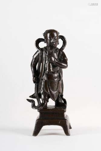 Chinese Art A dark bronze figure of a Buddhist character holding a Tibetan bell China, Ming dynasty