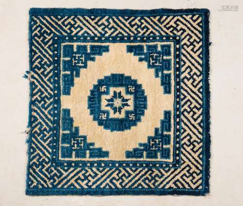 Chinese Art A Ningxia carpet decorated with blue geometrical motifs over cream ground China, late 19th century