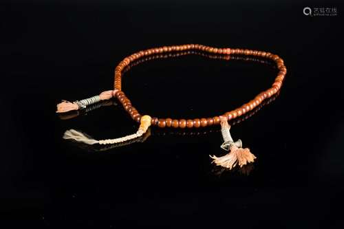 Himalayan Art An amber or vegetal resin and coral mala Tibet, 19th century