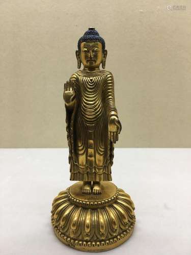 Himalayan Art A gilt bronze figure of standing Udayana Buddha. Yongle six character mark engraved at the base and possibly of the period