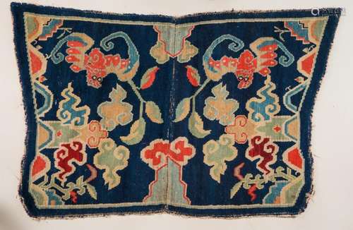 Himalayan Art A butterfly shaped saddle carpet decorated with bats, clouds and flowers over blue ground