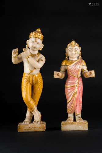 Indian Art A pair of polychrome marble sculptures portraying Lord Krishna playing the flute and Rada India, late 19th century