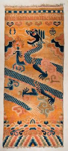 Himalayan Art A Tibetan carpet depicting a blue dragon over orange ground