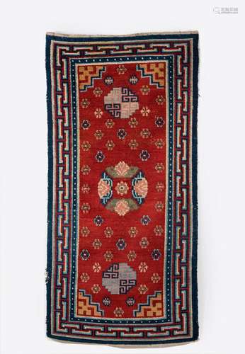 Himalayan Art A red ground carpet decorated with flowers Tibet, late 19th century