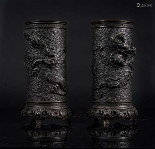 Japanese Art A pair of dark bronze vases decorated with dragons in relief Japan, 19th century