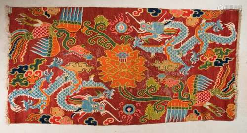 Himalayan Art A Tibetan carpet decorated with dragons, phoenixes and peonies over red ground