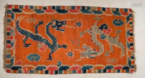 Himalayan Art A Tibetan carpet decorated with two blue dragons over orange ground