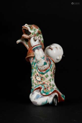 Chinese Art An enamelled pottery figure depicting a boy and a dragon China, Qing dynasty, 18th century