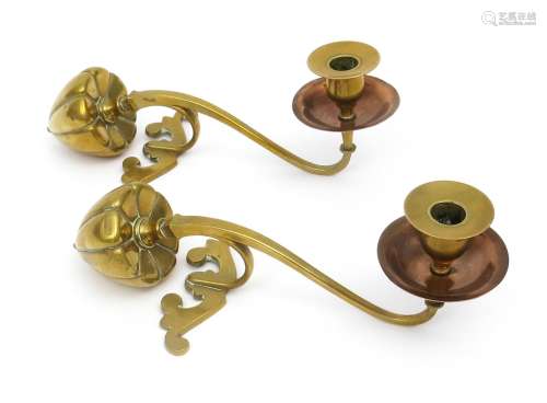 A pair of W.A.S Benson copper and brass mantelpiece candlesticks