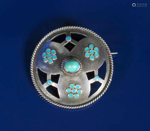 A silver and enamel brooch