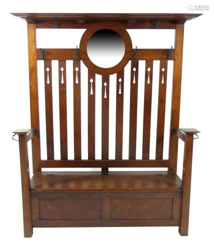 An Arts and Crafts oak hall settle probably by J S Henry