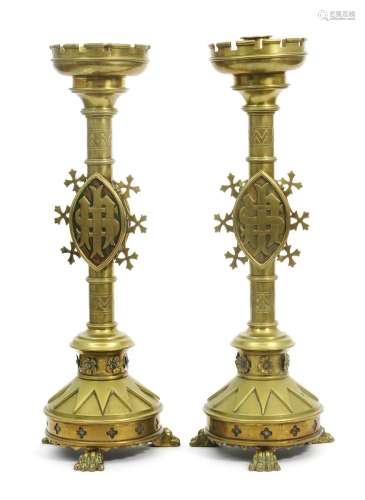 A pair of Gothic Revival brass candlesticks