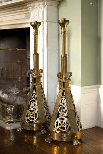 A pair of massive floor standing Aesthetic Movement brass candlesticks
