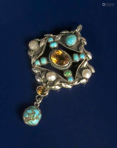 A silver and turquoise pendant