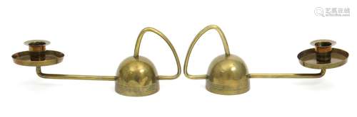 A pair of German Secessionist brass chambersticks in the manner of Richard Riemerschmid