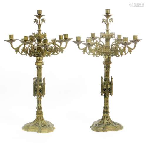 A pair of Gothic Revival brass candlesticks in the manner of A.W.N Pugin