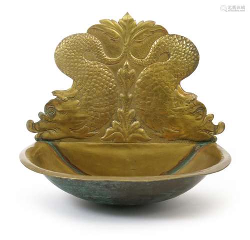 A repousse brass wall basin