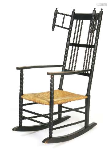 An ebonised ash rocking chair designed by Ernest Gimson