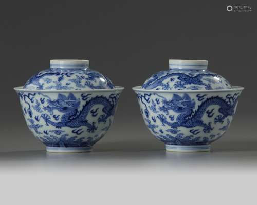 A pair of Chinese blue and white 'dragon' bowls and covers