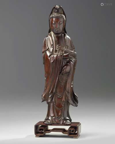 A Chinese hongmu carving of Guanyin and stand