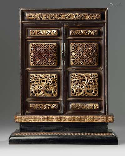 A Chinese gilt-lacquered carved wood altar cabinet