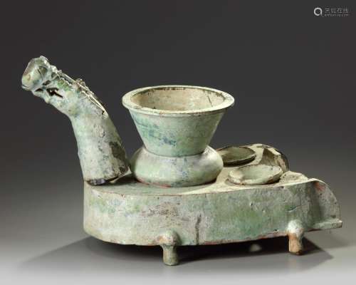 A Chinese green-glazed pottery stove with a dragon chimney