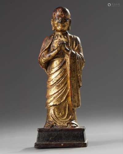A Chinese gilt-lacquered bronze figure of a monk