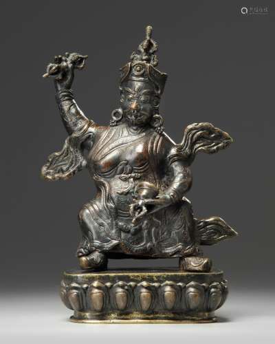A Tibetan bronze figure of Vajrapani with stand