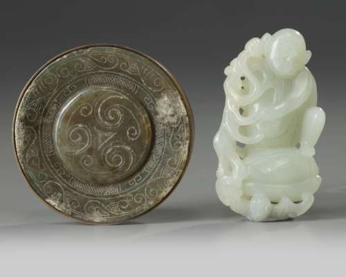 A Chinese celadon jade pommel and a pale celadon jade monkey