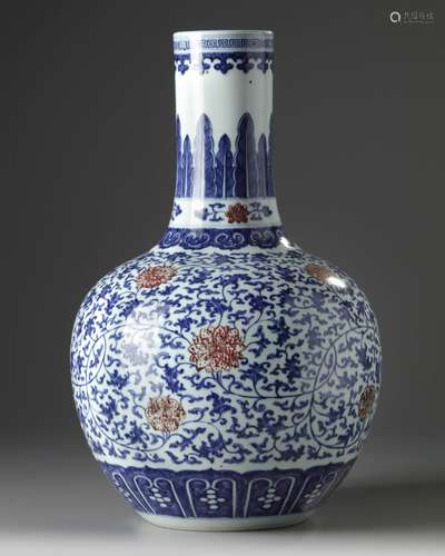 A Chinese blue and white and underglaze copper red-decorated flower scroll bottle vase