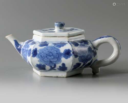 A Chinese blue and white 'peonies' hexagonal teapot and a cover