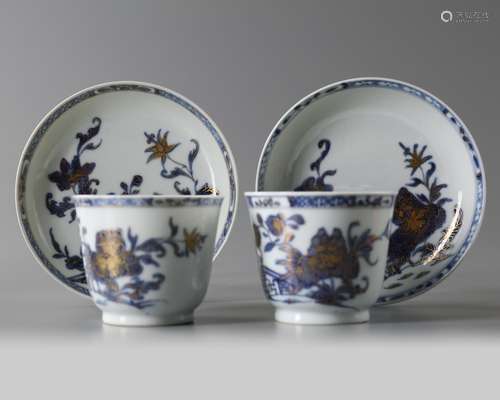 A pair of Chinese blue and white peony cups and saucers