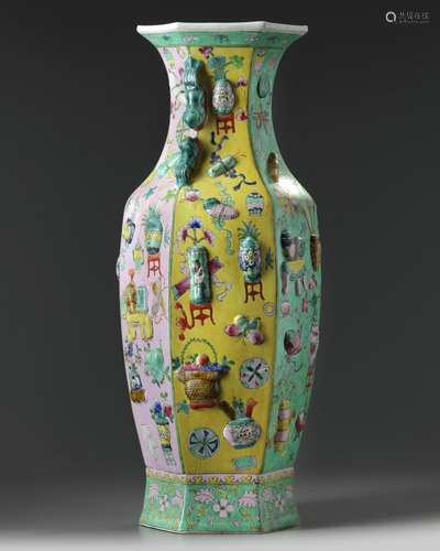 A large Chinese famille rose moulded 'precious objects' hexagonal vase