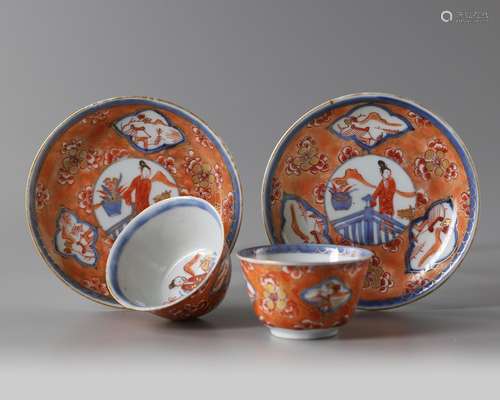 A pair of Chinese iron-red-decorated 'Chang'e and rabbit' cups and saucers