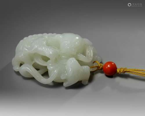 A Chinese white jade 'Buddhist lion and cubs' carving