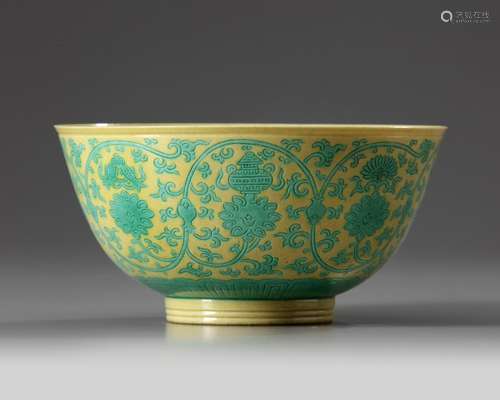 A Chinese yellow-ground green-enamelled 'Eight Buddhist Emblems' bowl