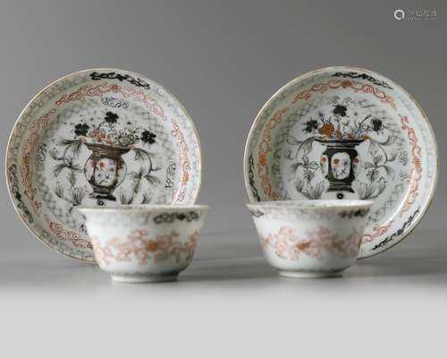 A pair of Chinese en grisaille and iron-red-decorated cups and saucers