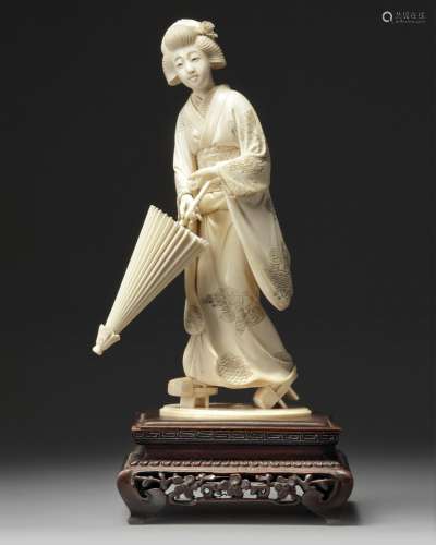 An ivory carving of a geisha holding a parasol