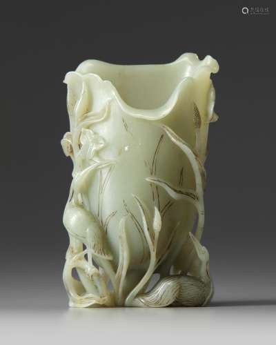 A Chinese celadon jade crane and lotus spill vase